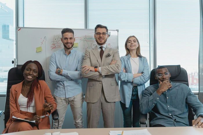 people-standing-together-wearing-formal-outfit-inside-an-office